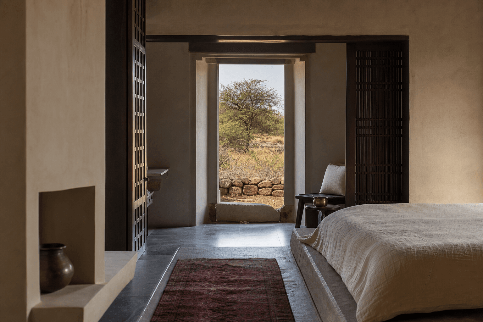 A lime-plaster suite opening toward a khejri tree